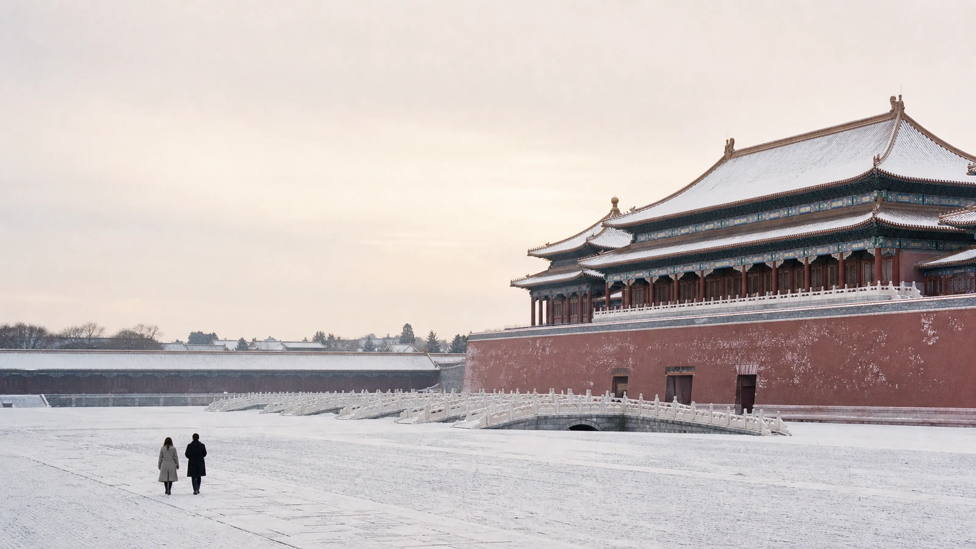 The Forbidden City after overnight snow — one couple walking the empty courtyard